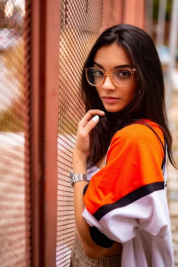 Woman Standing Beside Fence