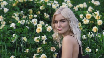 Woman Standing Beside Flower Garden