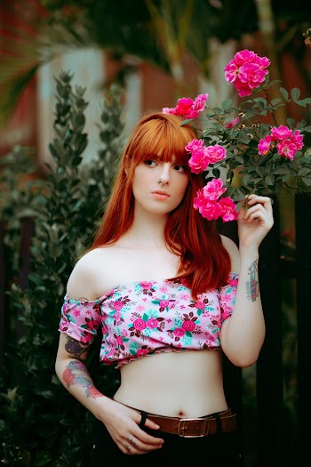 Woman Standing Beside Flowers
