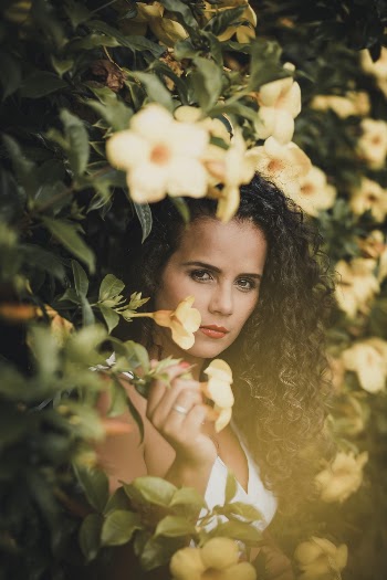 Woman Standing Beside Flowers