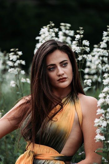 Woman Standing Beside Flowers