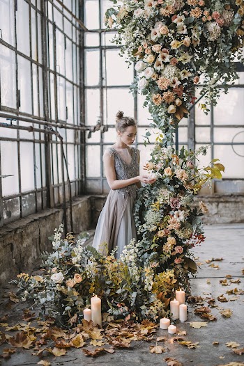 Woman Standing Beside Flowers Inside Building