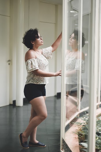 Woman Standing Beside Glass Wall
