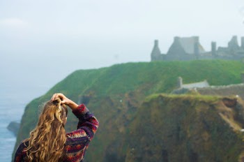Woman Standing Beside Green and Brown Mountain