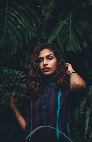 Woman Standing Beside Green Leaf Plant