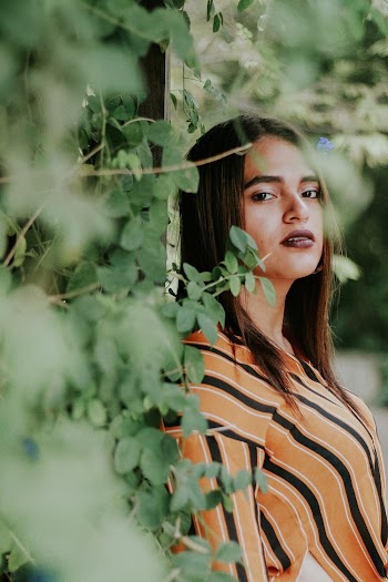 Woman Standing Beside Green Leafed Plant