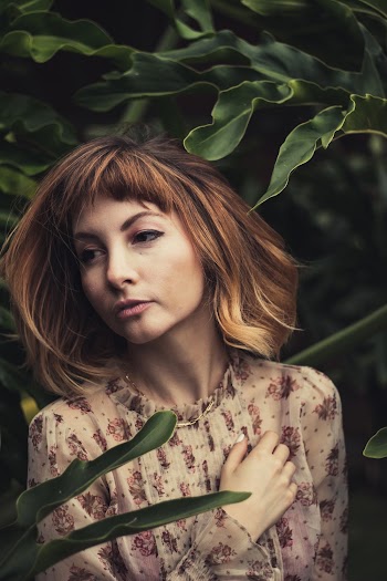 Woman Standing Beside Green Leafed Plant
