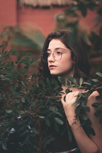 Woman Standing Beside Green-leafed Plant