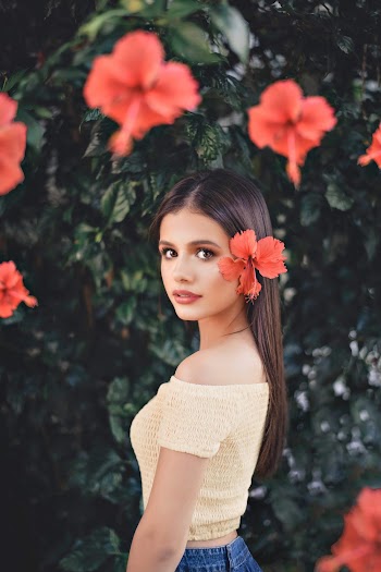 Woman Standing Beside Hibiscus Flower