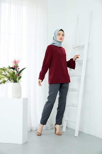 Woman Standing Beside Ladder on Wall