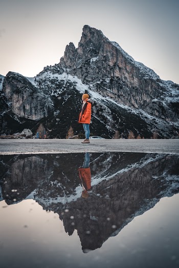Woman Standing Beside Lake and Mountain