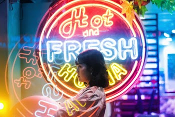 Woman Standing Beside Led Signage