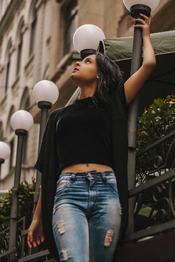 Woman Standing Beside Light Pole