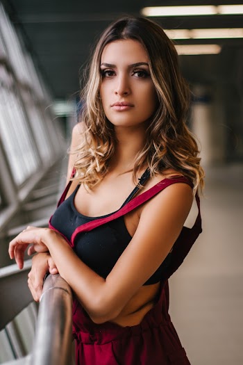 Woman Standing Beside Metal Railings
