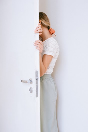 Woman Standing Beside Open Door