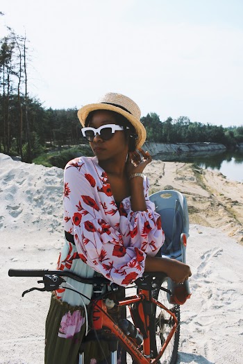 Woman Standing Beside Orange Mountain Bike