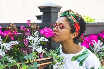 Woman Standing Beside Purple Flowers