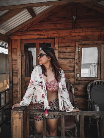Woman Standing Beside Railing On A Veranda