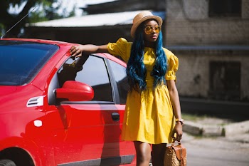 Woman Standing Beside Red Car