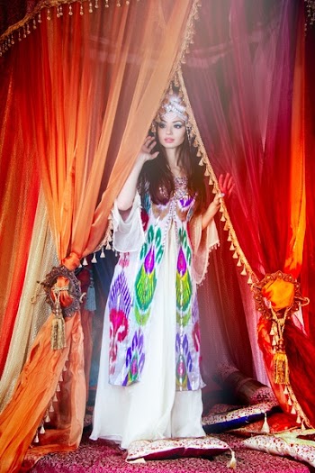 Woman Standing Beside Red Curtains