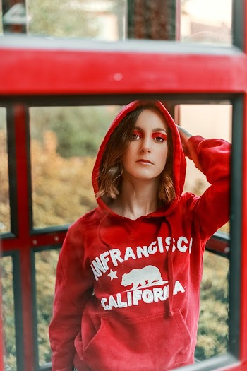 Woman Standing Beside Red Obstacle Frame