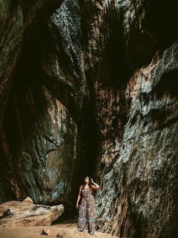 Woman Standing beside rocks