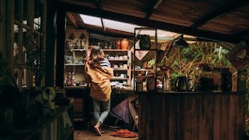 Woman Standing Beside Shelf