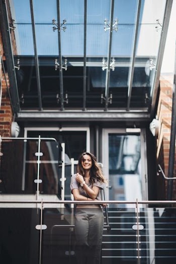 woman standing beside terrace