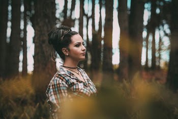 woman standing beside tree in forest