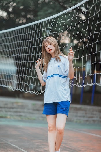 Woman Standing Beside Volley Ball Net