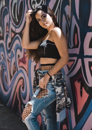 Woman Standing Beside Wall With Graffiti