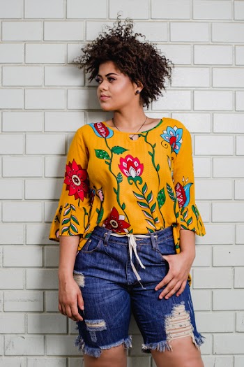 Woman Standing Beside White Concrete Wall