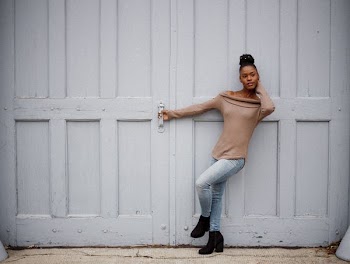 woman standing beside white door