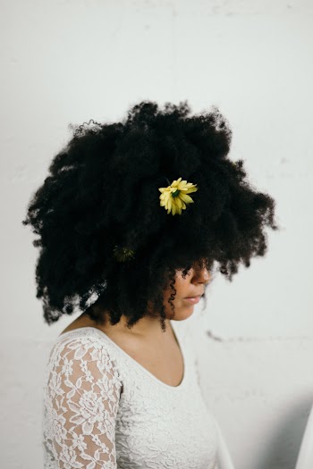 Woman Standing Beside White Wall
