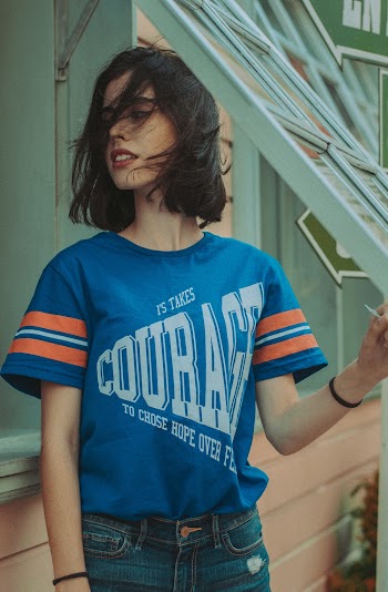 Woman Standing Beside Windows