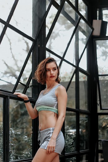 Woman Standing Beside Windows