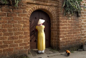 Woman Standing Beside Wooden Door