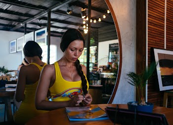 Woman Standing Beside Wooden Table