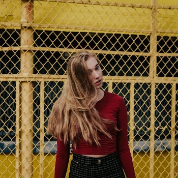 woman standing beside yellow steel frame