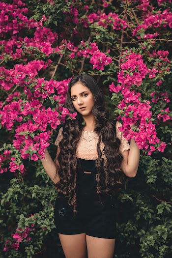 Woman Standing Besides Pink Flowers