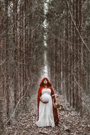 Woman Standing Between Brown Trees