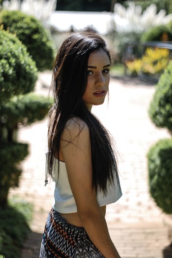 Woman Standing Between Bushes