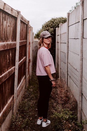 Woman Standing Between Fences