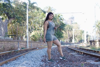 Woman Standing Between Railways
