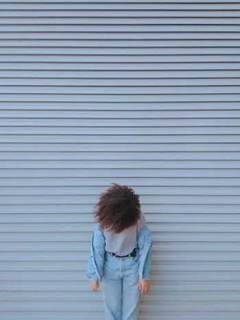 Woman Standing by Closed Shutter Door