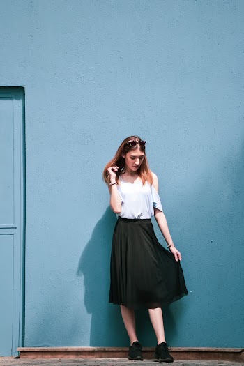 Woman Standing by the Blue Wall