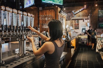 Woman Standing Facing Soda Dispenser