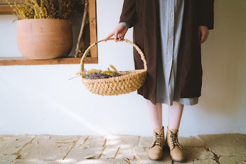 Woman Standing Holding A Basket