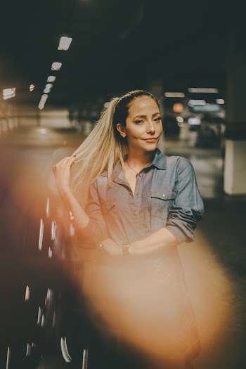 Woman standing holding her hair