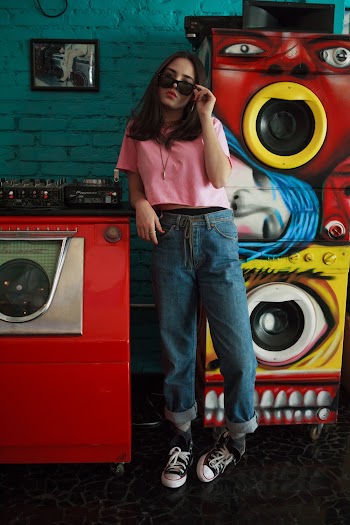 Woman Standing Holding Her Sunglasses